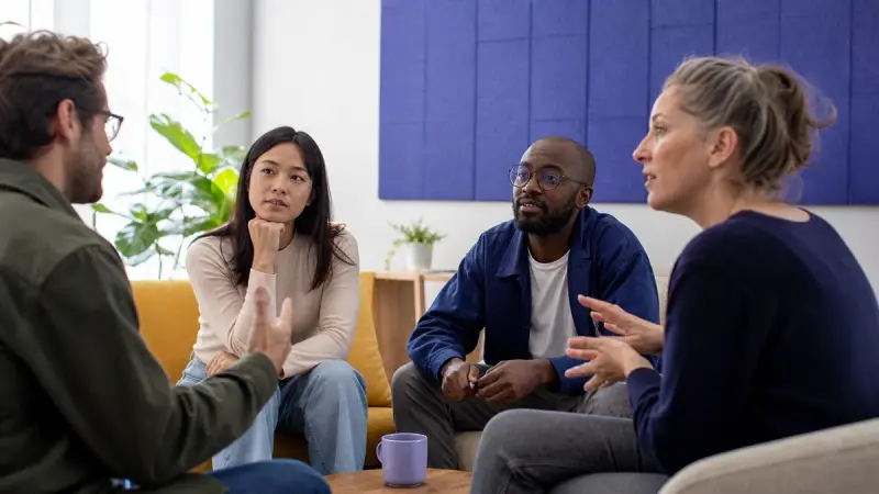 An English learner listening to several different speakers in a casual meetup