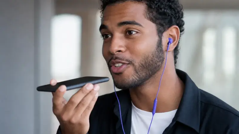 Man practicing a foreign language with a voice message