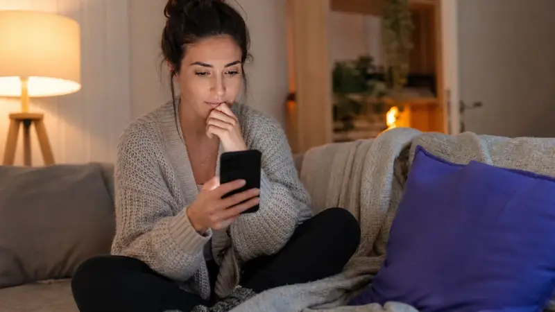 Woman comparing Spanish learning apps at home