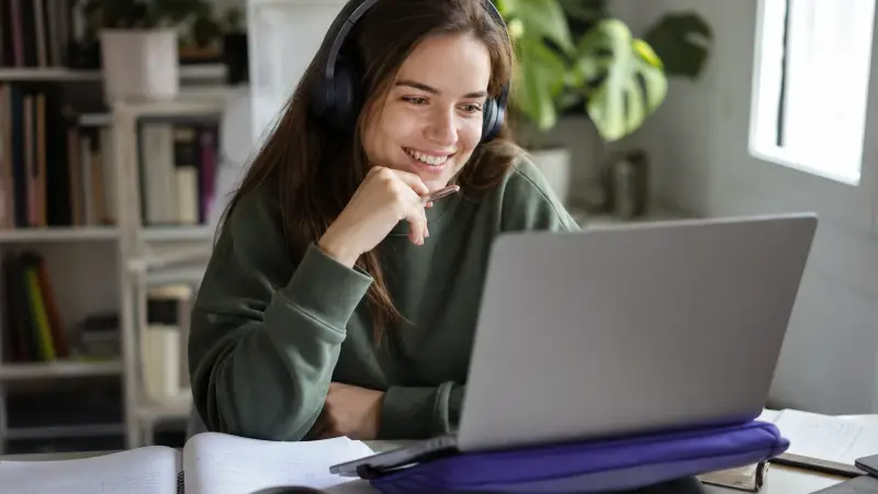 Woman learning French online with a laptop